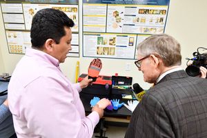 Researcher Eduardo Sosa talks about his research with safety gloves to help the mining industry reduce lost-time accidents with WVU President Gordon Gee
