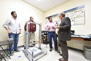 WVU President Gordon Gee interviews Eduardo Sosa and team members Faisel Alessa, a Ph.D. student from Saudi Arabia, and Trevor Brison, a mechanical engineering student from Morgantown. 