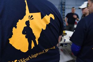 A coal miner and West Virginia University logo on the back of a t-shirt.